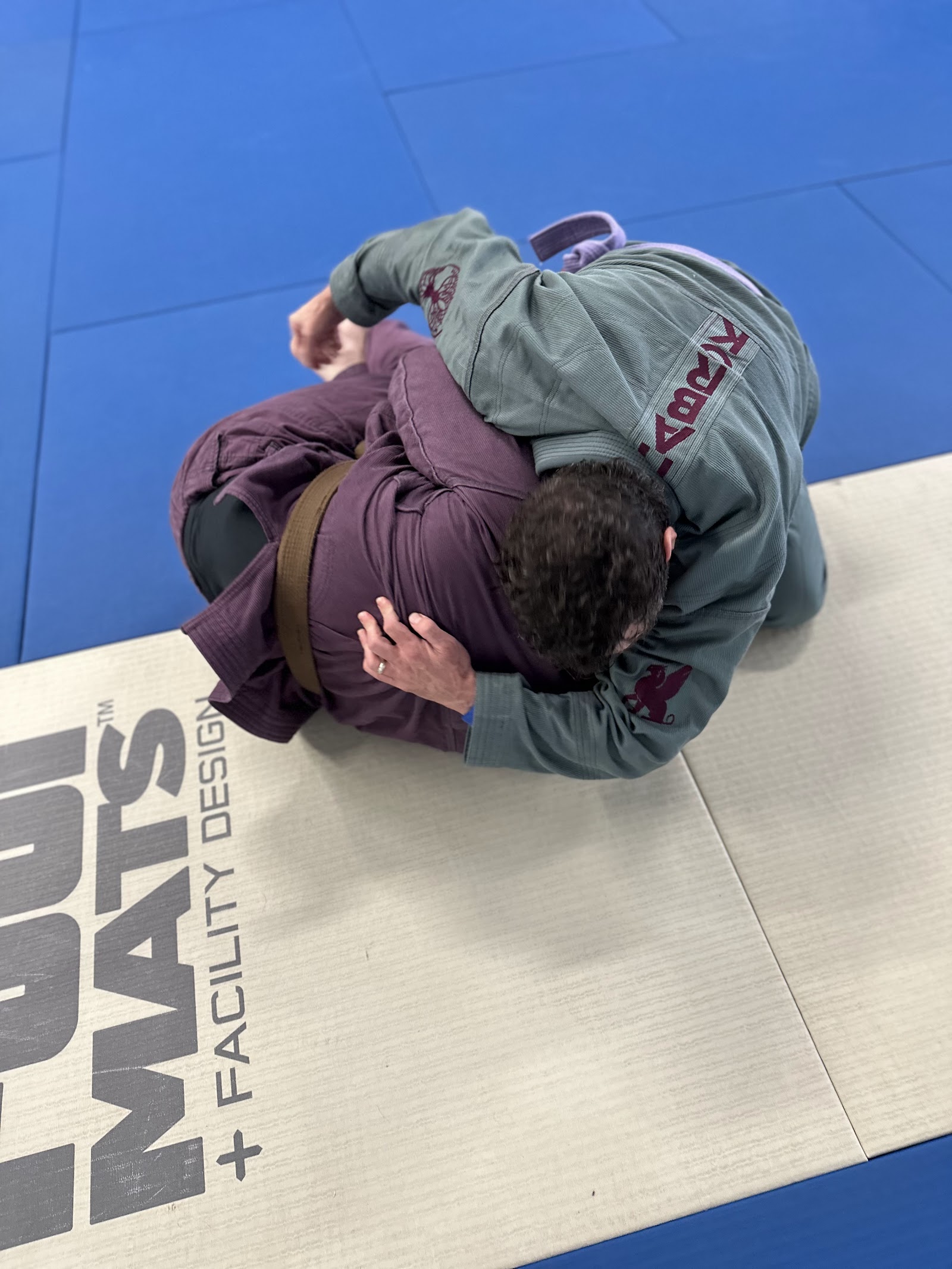 Two adults grappling in gis during BJJ class at Stoic Martial Arts in Chanhassen, Minnesota
