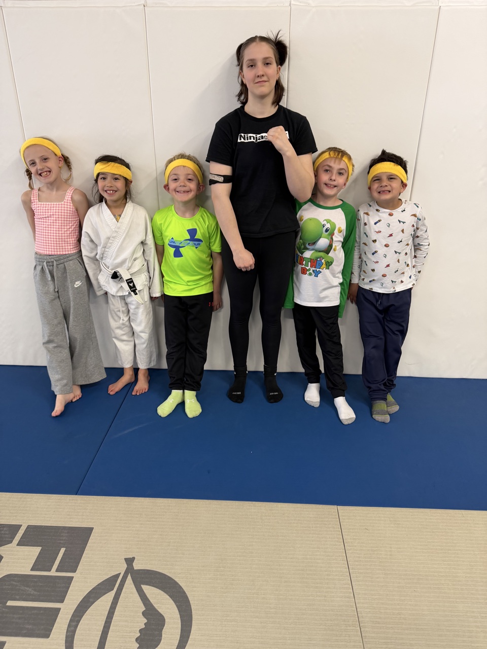 Coach and kids in ninja headbands at a kids class at Stoic Martial Arts in Chanhassen, Minnesota
